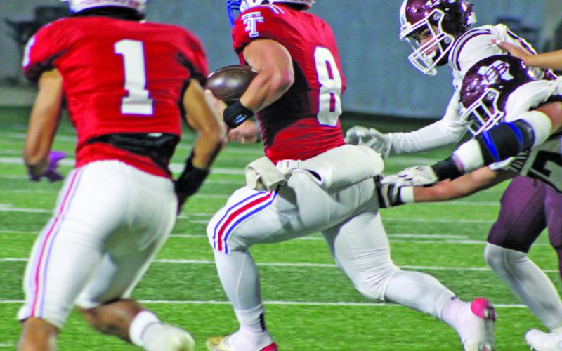 Sentinel Photos/MaLinda and Mike Reddell Tidehaven quarterback Kale Russell breaks through East Bernard defenders en route to a big gain.