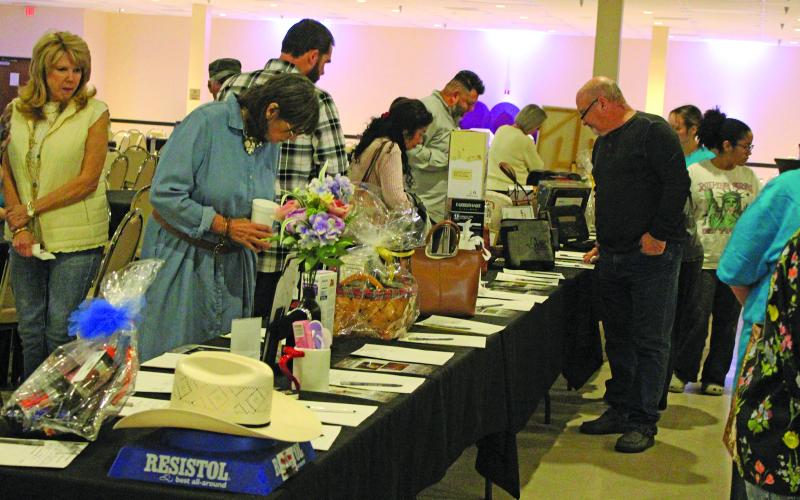 Sentinel Photo/Jessica Shepard People browse through the tables filled with auction items for “18th Annual Chicken Fried Steak Dinner Crisis Center Fundraiser” Friday night, Jan. 16.