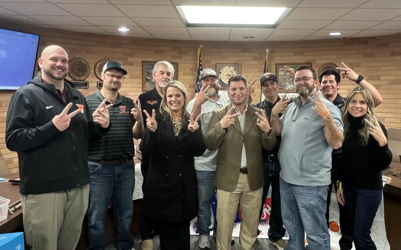 VVISD photo New VVISD Athletic Director and Head Football Coach Cody Carney (center right) joins Superintendent Christie Dement and trustees in flashing Leopard cheer symbol.