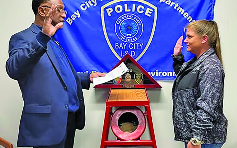 BCISD photo Bay City ISD Police Chief Leroy Cunningham administers the oath to new BCISD Officer Lacey Gilbert who has many years of law enforcement experience.