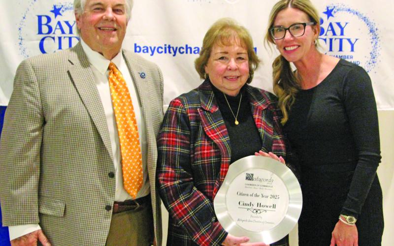 Sentinel Photo/Jessica Shepard Cindy Howell shows off her Matagorda Citizen of the Year 2025 honor at the Bay City Chamber of Commerce &amp; Agriculture at its banquet Jan. 15. Shown with Howell are outgoing board chair John Dickerson and Chair-elect Savannah Cornelius.