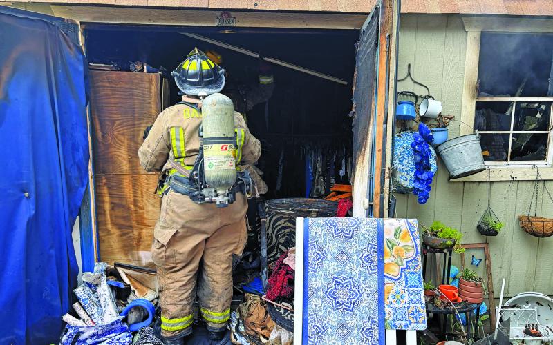 Contributed photo A Bay City firefighter checks the interior of a shed that caught fire.