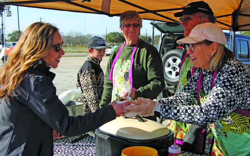 Sentinel Photo/Jessica Shepard Bay City Councilwoman Susan Reardon, left, gets a sample from one of several cook teams at the Matagorda County Youth Charities' "Taste &amp; Tunes" fundraising event on Saturday, Jan. 17.