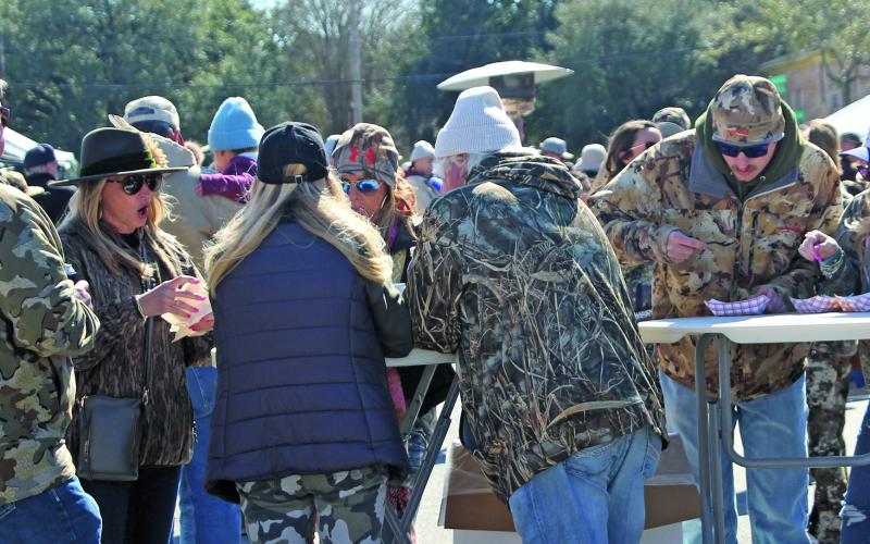 Sentinel Photo/Jessica Shepard Camofest patrons ignore the brisk winds and temperatures Saturday, Jan. 31, to enjoy the 10th annual event’s "Food Camp" with locally sourced wild game, including deer chili, alongside various fish and fowl dishes. The event also featured Texas wines, beers, and vendor-sold food items. This group of diners also exhibited the camo wear that’s part of the event’s theme.