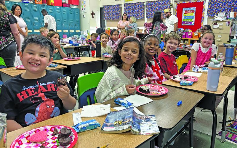Contributed photo The Second Grade at Holy Cross Catholic School takes a moment to smile between their cookies and goodies.