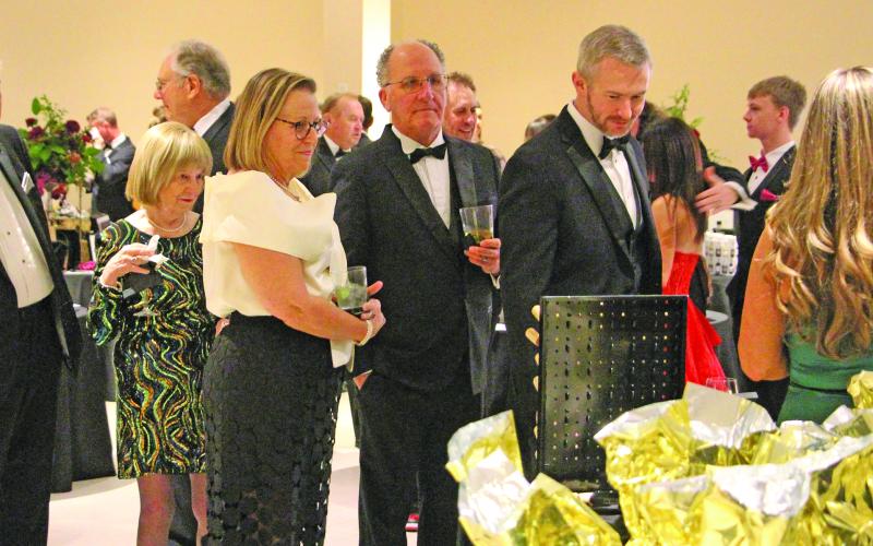 Sentinel Photo/Jessica Shepard Guests at the Junior Service League Charity Ball, Saturday, Feb. 7, form a line of prospective silent auction buyers.