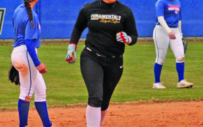 Lady Cat has a smile rounding second as she belted a homer over the fence