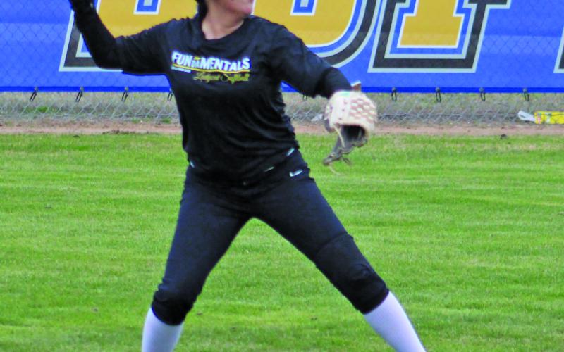 Lady Cat outfielder fires ball to second.
