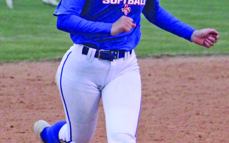 A Tidehaven player heads for third after getting a solid base hit.