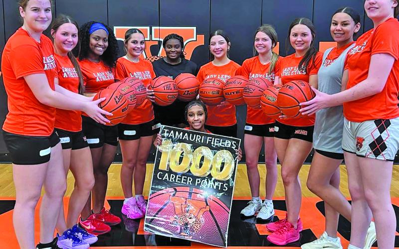 Van Vleck photo Last week, junior Tamauri Fields reached an incredible milestone - 1,000 career points as a Lady Lep varsity basketball player. Above, Fields’ teammates help her celebrate.
