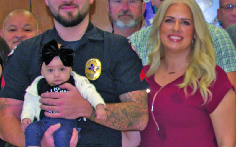 BCPD photo Newly promoted Bay City Police Department corporal Dillon Wakefield and his soulmate Angelyna introduce one of their three children at Wakefield’s recent promotion ceremony.