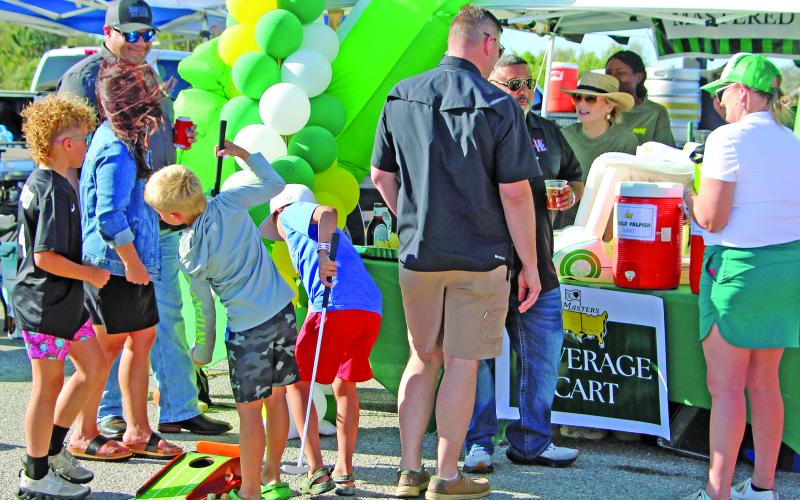 Sentinel Photo/Jessica Shepard Great Steak Cook Off attendees tried their luck at putting for fun at the “Beverage Cart” cook team tent during the Bay City ISD Education Foundation’s annual fundraiser on Saturday, March 21.