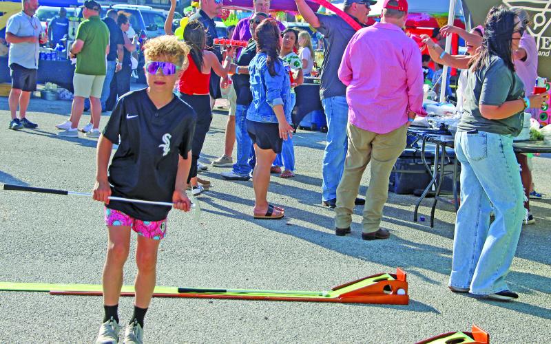 Sentinel Photo/Jessica Shepard Great Steak Cook Off attendees tried their luck at putting for fun at the “Beverage Cart” cook team tent during the Bay City ISD Education Foundation’s annual fundraiser on Saturday, March 21