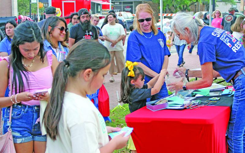Sentinel Photo/Jessica Shepard Crisis Center officials are calling the 6th Annual Light Up the Square event Thursday, April 9, at the courthouse square the largest crowd ever. People of all ages joined in calling attention to Child Abuse &amp; Sexual Assault Awareness.