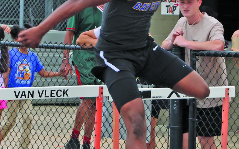 Sentinel Photo/Mike Reddell Bay City’s Jaylen Harris clears the hurtles at the Van Vleck Pre-District Warm-up meet last week.