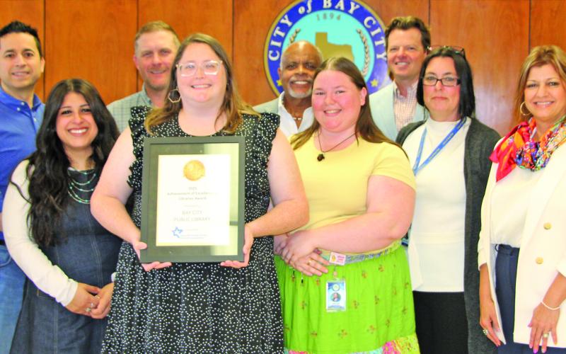 Sentinel Photo/Mike Reddell Samantha Denbow, Communication and Cultural Arts Director, shows off the 2025 TMLDA Achievement of Excellence in Libraries Award she presented to City Council March 24.