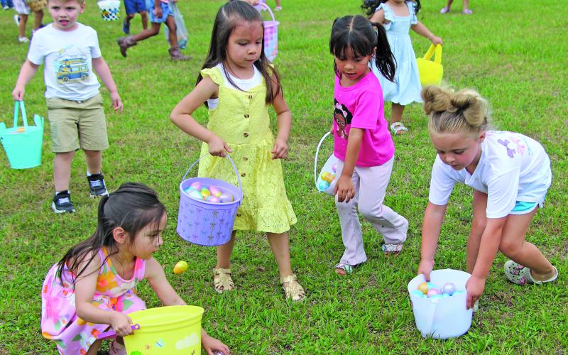 Sentinel Photo/Jessica Shepard These little girls seem to have an area selected to load up and fill their Easter baskets with eggs during Bay City Parks &amp; Recreation Department's "Annual Easter Egg-Stravaganza" in LeTulle Park on Friday, April 3..