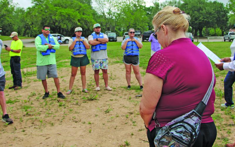 Sentinel Photo/Mike Reddell Kelly Penewitt, above, joins Mayor Robert Nelson as he reads the city’s Water Safety Month Proclamation at the Saturday Rally on the River 2026 to the participating paddlers. The event marked the official opening of the newest TPWD Paddling Trail section. Paddlers, below, prepare to launch their craft at the Riverside Park boat ramp for the 7-mile journey.