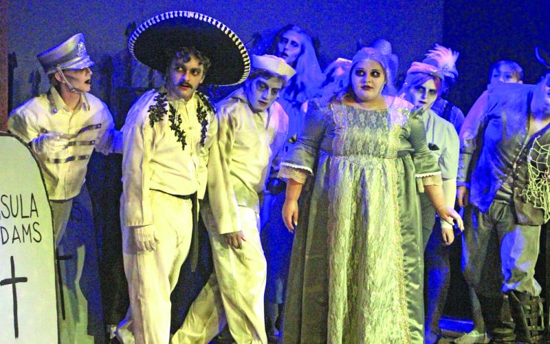 Sentinel Photo/Jessica Shepard Several ghosts of Addams Family members past look on as current members discuss plans for an upcoming dinner event during the production's press night July 29. Over two dozen actors and actresses are part of CAST's "The Addams Family" musical comedy wrapping up this weekend.