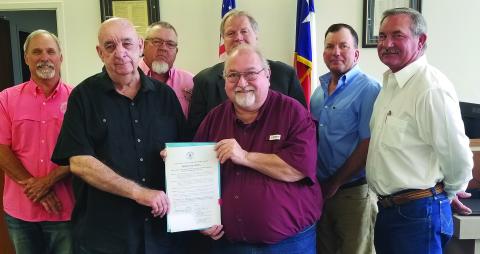 Sentinel Photo/Mike Reddell Commissioners Court approved a proclamation Monday declaring June as Myasthenia Gravis Awareness Month. In front are Edward Gillett from Palacios and Simon DeSoto of Bay City, both of whom have the disease. Back of them are, from left: Commissioners Bubba Cook and Bubba Frick; County Judge Bobby Seiferman; and Commissioner Troy Shimek.