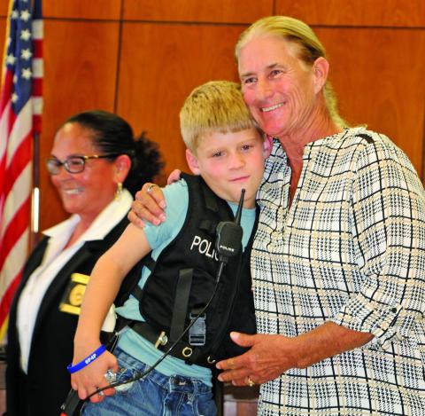 Owen Lyons gets a hug from Suzanne Sullivan, after Chief Christella Rodriguez gives him oath of office. Sentinel photo: Mike Reddell