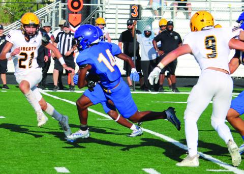 Sentinel Photo/Mike Reddell Above, senior Blackcat running back Paris Fox (14) picks up yardage against Liberty in the scrimmage here Friday, Aug. 11.