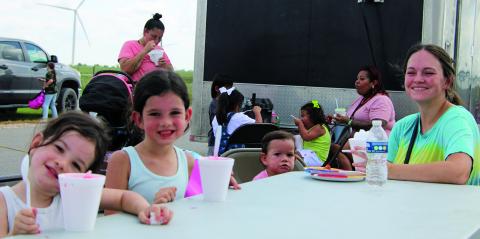 Sentinel Photo/Mike Reddell About 200 backpacks were given away at the Peyton Creek Wind Farm Annual School Supply Drive Tuesday, Aug. 8. In addition to the backpacks, Peyton Creek provided Texas Best Snowballs and Full Moon Wood Fired Pizza. Above, Jade Fox of Bay City, with her three children, from left, at Peyton Creek: Phoenix, 3, Lyra, 5, and Nova, 1.  