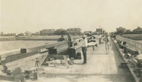 Photo courtesy of City by the Sea Museum Men working on the pavilion pier with the seawall being constructed in the background, c. 1935.