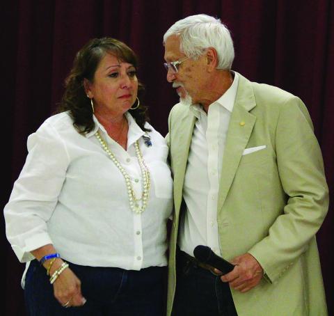Sentinel Photo/Jessica Shepard Cynthia “Cindy” Delgado is shown with District Attorney Steven Reis as the 100 Club presented the widow of BCPD officer Juan Delgado with a $20,000 check from the club.