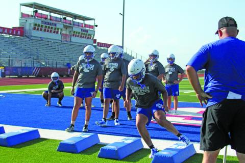 Anna Hernandez photo A Tidehaven coach watches as players go through an agility drill last week.
