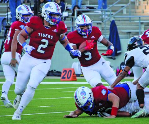 Sentinel Photos/Mike Reddell Tiger back Jachen Duran (2) prepares to block for back Josphen Dodds (5) to gain yardage against Rogers. 
