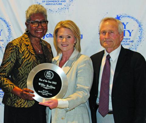 Sentinel Photo/Jessica Shepard Audrey Rollins, left, accepts the award for Man of the Year in behalf of her late husband Willie Rollins from Danyel Biggerstaff, outgoing board chair, and Arthur Milberger, 2021 recipient of the honor.