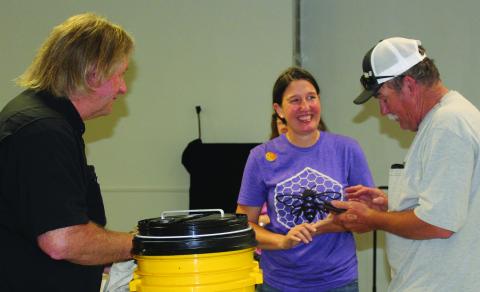 Sentinel Photo/Jessica Shepard Bee Love TX owner Cheryl Wilson, center, discusses various types of equipment needed for apiaries and beekeeping after her "Beekeeping 101 workshop" last week. Wilson partnered with the Matagorda County Texas A&M AgriLife Extension Office to host the event April 30.