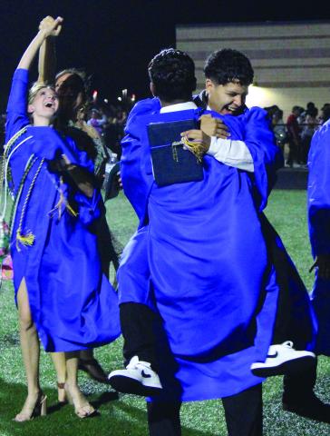 Sentinel Photo/Jessica Shepard Bay City High School's 216 graduating seniors shared their excitement with each other in various easy form hugs to striking energetic poses May 24.