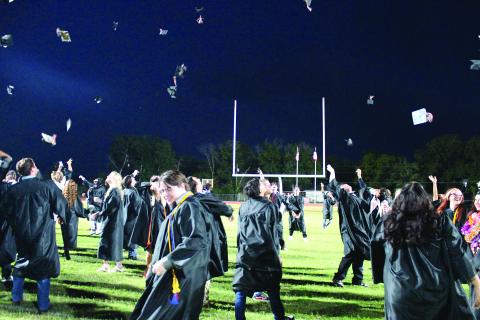 Sentinel Photo/Jessica Shepard Van Vleck graduates hustled to the south end of the football field to toss their caps to celebrate their commencement Thursday, May 23.