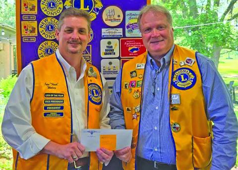Bay City Lions Cluib President Bobby Seiferman presented Lion John Woolsey with the Wharton County Junior College Vocational Program a $3,000 scholarship check for the new carpentry school. Contributed photo