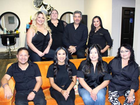 Sentinel Photo/Jessica Shepard Salon & Spa owner Nicasio Perez, center back, celebrated his business' 10th anniversary on Friday, June 7. The salon is located at 2905 Ave. F in Bay City.