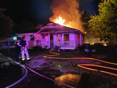 Contributed photo Firefighters battle a blaze at a Palacios residence July 1.
