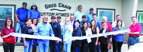 Greg Crain Custom Homes partnered with the Bay City Chamber of Commerce & Agriculture for an open house ribbon-cutting ceremony on July 24. Crain, center, is joined by Richie and Nancy Mayhew and several employees at the event. The business is located at 520 Ave. F in Bay City. Sentinel Photo/ Jesssica Shepard