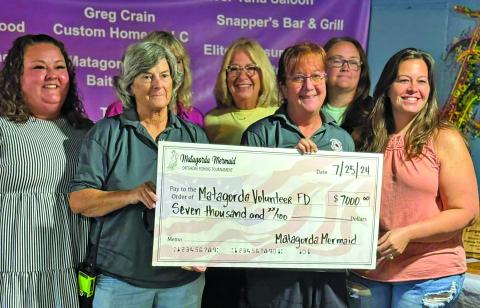 Courtesy photo Ashley Lubbers, Laura Marshall, Gail Krejki, and Courtney Perrosky with Matagorda Mermaid Tournament donated funds to the Matagorda Fire & Rescue (pictured), Matagorda Historical Society, Matagorda United Methodist Church Food Pantry, and Latchkey Program on July 25.