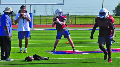 Sentinel photo/MaLinda Reddell New Tiger coach Bryce Galvan helps guide the Tidehaven passing drill.