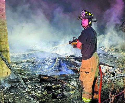 Contributed photo Firefighter battles the hot spots at a Van Vleck vacant house.