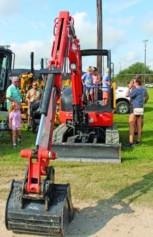 Sentinel Photo/MaLinda Reddell Children were temporarily behind the controls at an excavator under the watchful eyes of their parents at Touch-A-Truck Saturday at the Sports Complex on Saturday, Sept. 14. The fifth annual event was hosted by the Bay City Parks and Recreation Department.