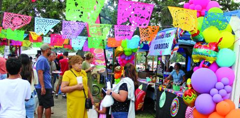 Sentinel Photo/Jessica Shepard Colorful decorations and tantalizing scents drew attendees to various food vendors at Our Lady of Guadalupe Church's annual "Parish Jamaica" event on Sunday, Sept. 15. The event also featured carnival games, live entertainment, a cake walk, and more.