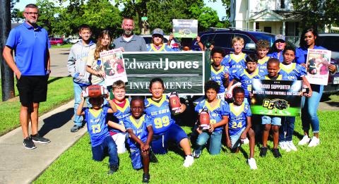 Sentinel Photo/Jessica Shepard James Scardami's Edward Jones Office and Marine Corps Toys for Tots recently donated the first batch of Bay City Youth Football and Cheer "Lil Cats" game balls for the season. Along with several Lil Cats team members and parents are, from left, Bay City Youth Football and Cheer President Israel Ochoa, Connor Scardami, Emily Scardami, and James Scardami.