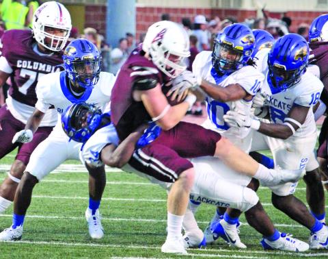 Sentinel Photo/Mike Reddell Bay City senior defensive end Cameron Spencer (34) pulls down a Roughneck running with Davont’A Harris (10) and Trevell Wells (18) moving in to help.