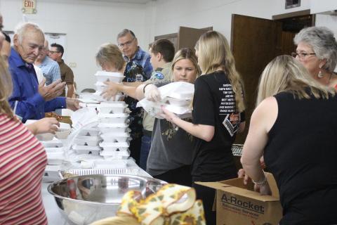 Sentinel Photo/Jessica Shepard Boxed lunches are prepared at the Holy Cross Catholic Church’s annual “Fall Festival and Turkey Dinner” Sunday, Sept. 29, at the Knights of Columbus Hall. In addition to the meals, the church’s event featured a live auction, raffle, country store, and children’s activities.