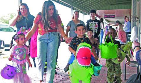 Sentinel Photo/Mike Reddell Halloween brought scores of trick-or-treaters to downtown last Thursday. Above, a few of the youngsters’ costumes on display.