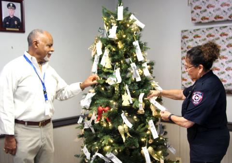  Mayor Robert Nelson and Police Chief, Christella  Rodriguez placing tributes on the Tree of Anges at Bay City Police Station Thursday, Dec 5. Sentinel photo/Jessica Shepard