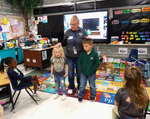 Sentinel Photo/Mike Reddell Juvenile Case Manager Ginger Iovanna and Court Clerk Lillie Norris from Bay City Municipal Court recently visited Holy Cross students. They shared important traffic safety information and promoted car seat safety by reading a book to the students, as well as general all-around safety.